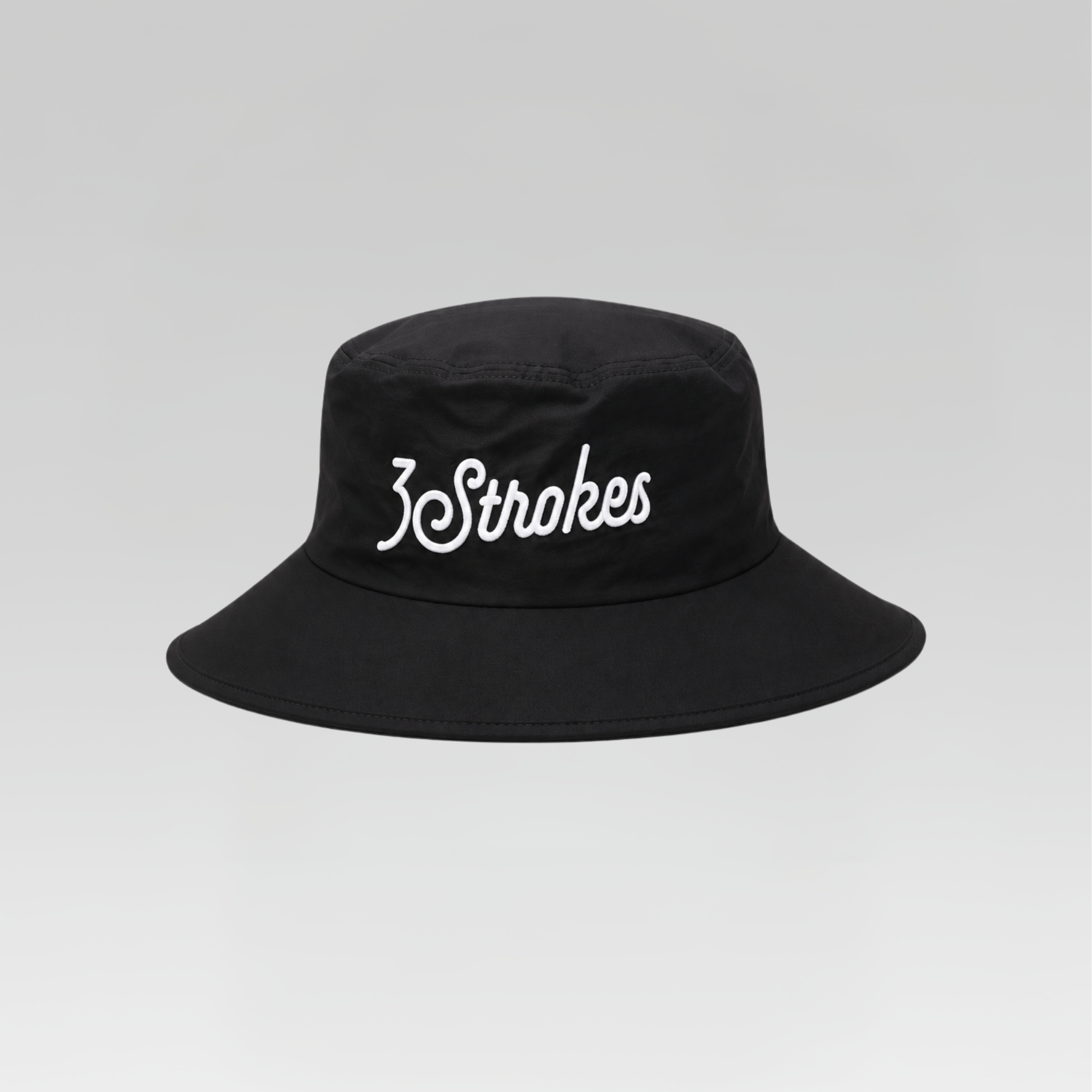 A black bucket hat with '3Strokes' embroidered in white script across the front, set against a neutral gray gradient background.